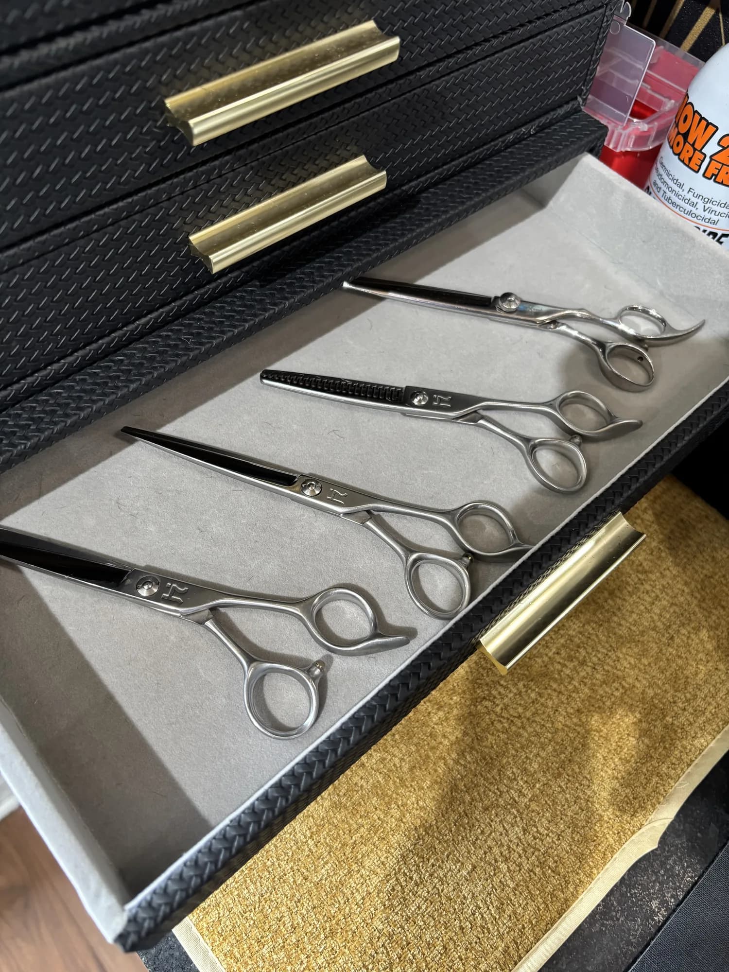 Scissors with gold handles in a drawer