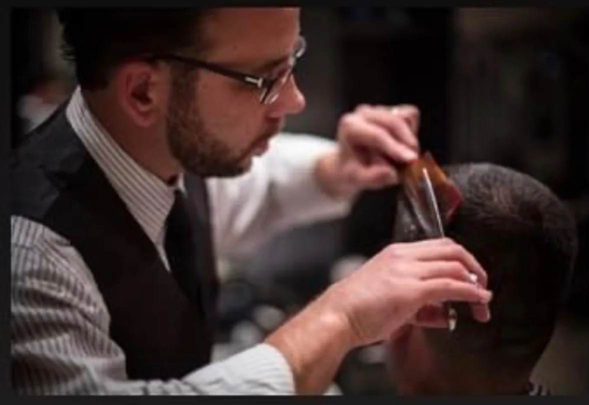 John cutting a client's hair